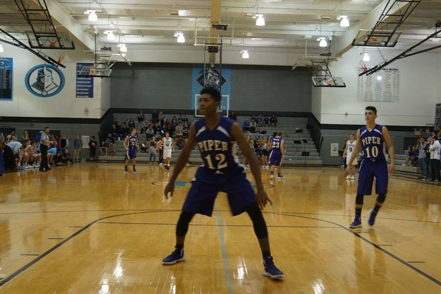 Juniors Terrell Hall and Jordan Goodpaster look to steal the inbounds pass from the Lancers. 