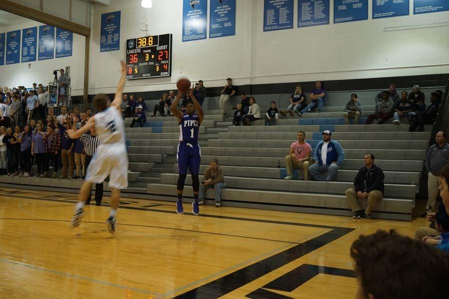 Sophomore Doc Covington attempts a three from the corner with a Lancer defender in his face.
