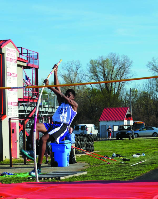 Sophomore Marcus Wallace bounces up and over the bar. He cleared the bar that round in pole vaulting at the track meet at Tonganoxie High School April 14.
