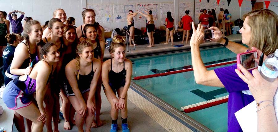 Swim coach Amy Bartlow snapped a picture of the varsity team before the meet began at Lawrence High School March 29.