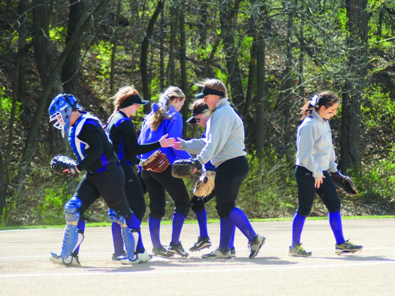 Sophomore Kamryn Sparks, senior Maddie McCall, junior Payton Nigh and senior Taylor Hall walk back to their positions after their pregame talk, while seniors Abby Henry and Brooklyn Lauritzen complete their pregame handshake, before their win against Bishop Ward.
