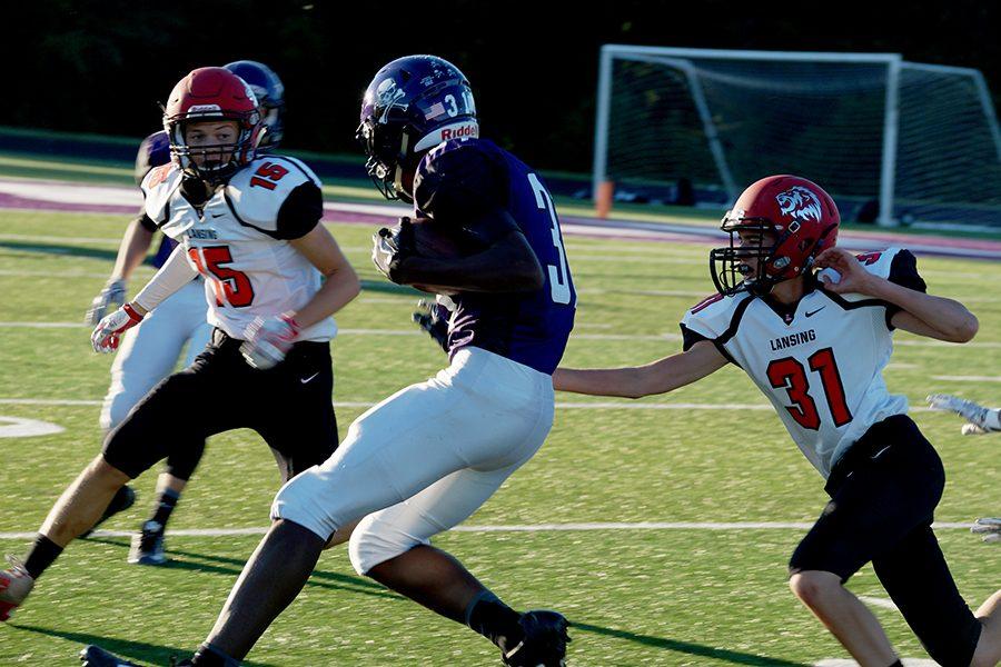 Junior Marcus Wallace looks to gain more yards after catching a pass. The Pirates won the game 20-0.