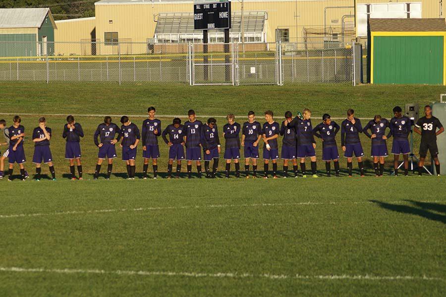 Varsity soccer team waiting on National Anthem.
