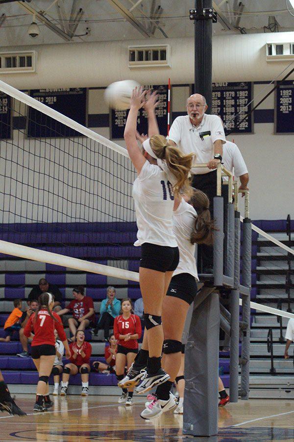 Sophomore Abby Woodall and Junior Riley Apperson go up for a block.