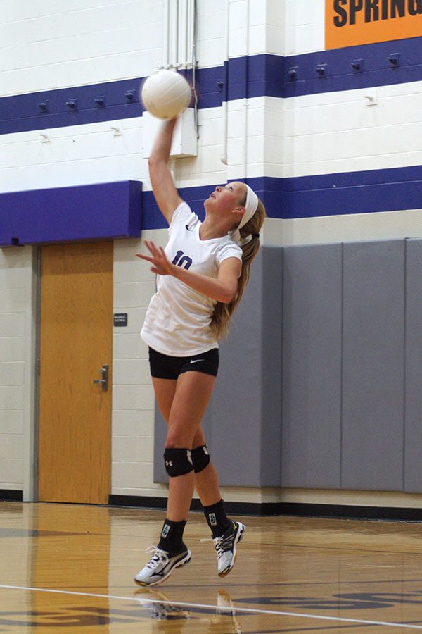 Sophomore Abby Woodall serves to other team.