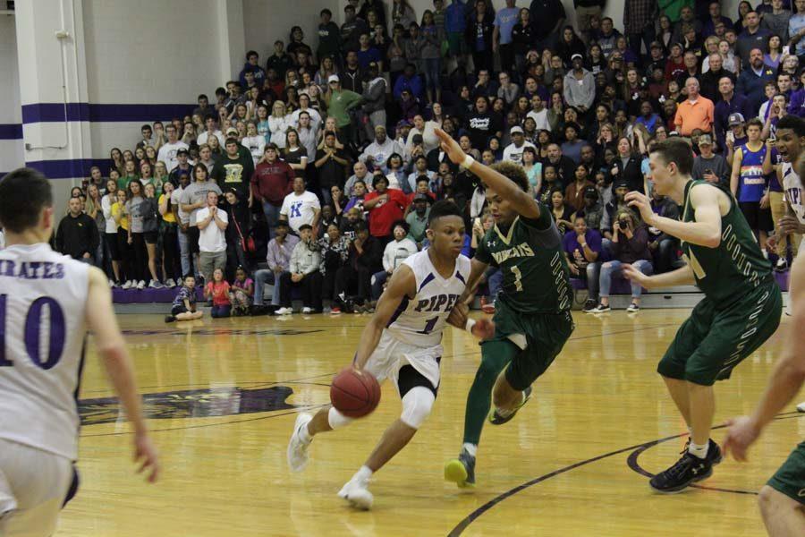 Junior Doc Covington drives to the basket in the fourth quarter against Basehor.