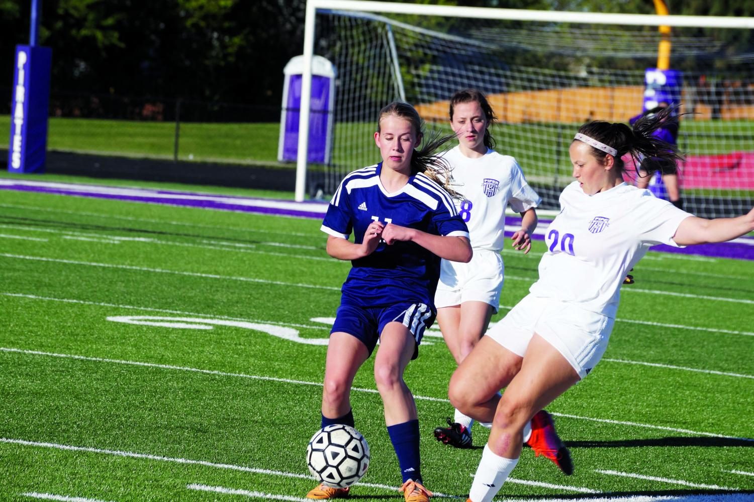 Junior Emily Wilson and Kayla Murray, senior, steal the ball for Piper.

