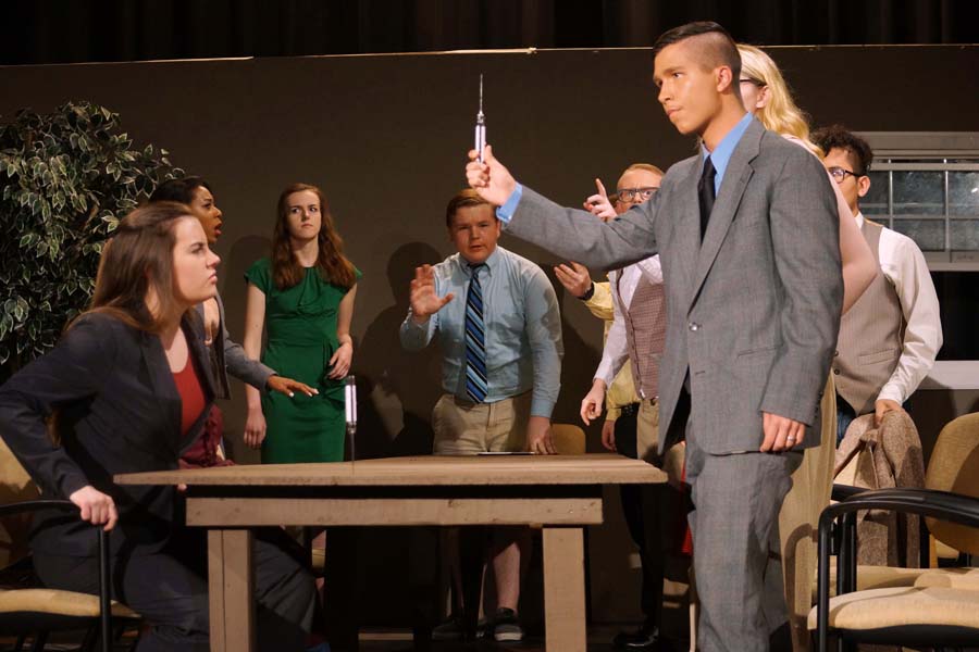 Junior, Isaia Wilcoxen, shows the other jurors the knife used in the murder.