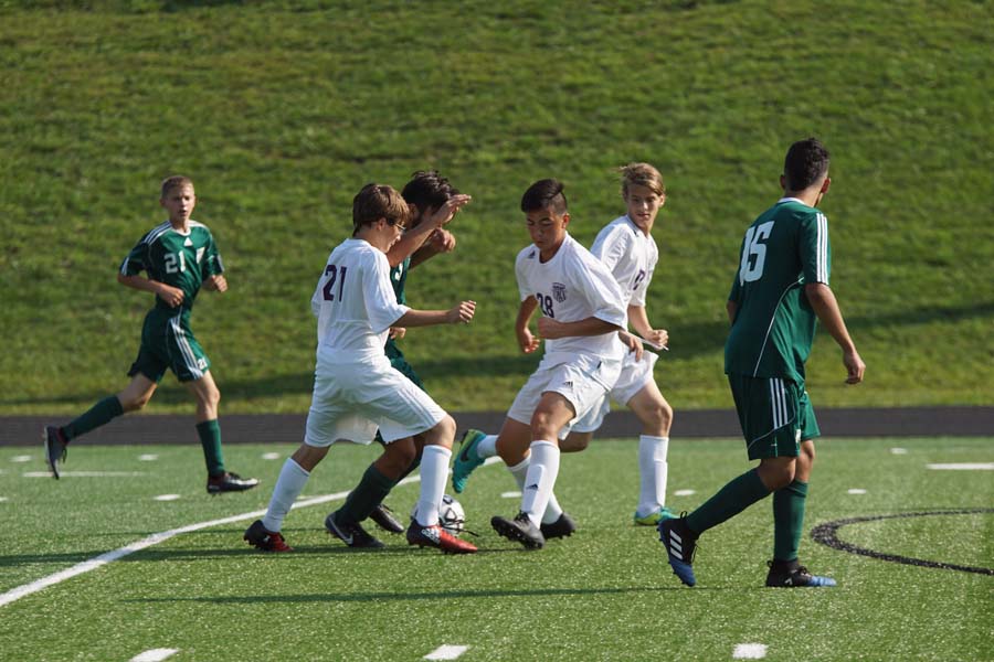Freshman #21 and #28 go in and succesfully win the ball away from a  De Soto striker in the game  Aug. 31, 2017.