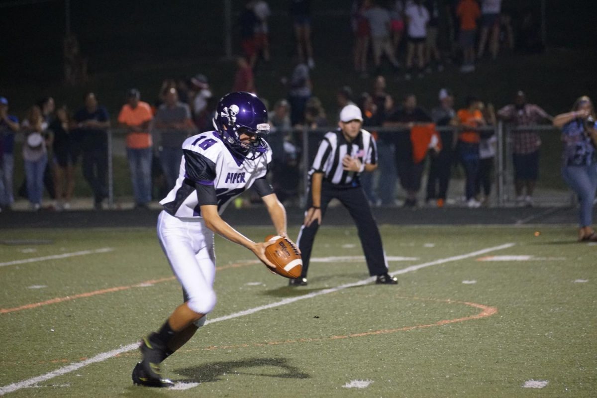 Junior Jonny Moon punts the ball after the Pirates were unable to move closer to the end zone. 