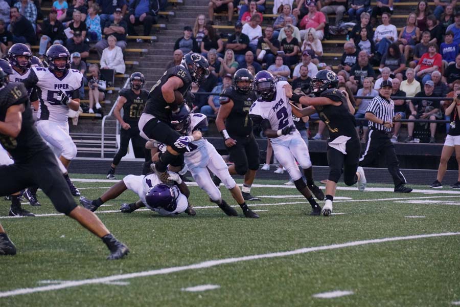 Junior Kaleb Brown tackles a Paola player, keeping them from scoring a touchdown.