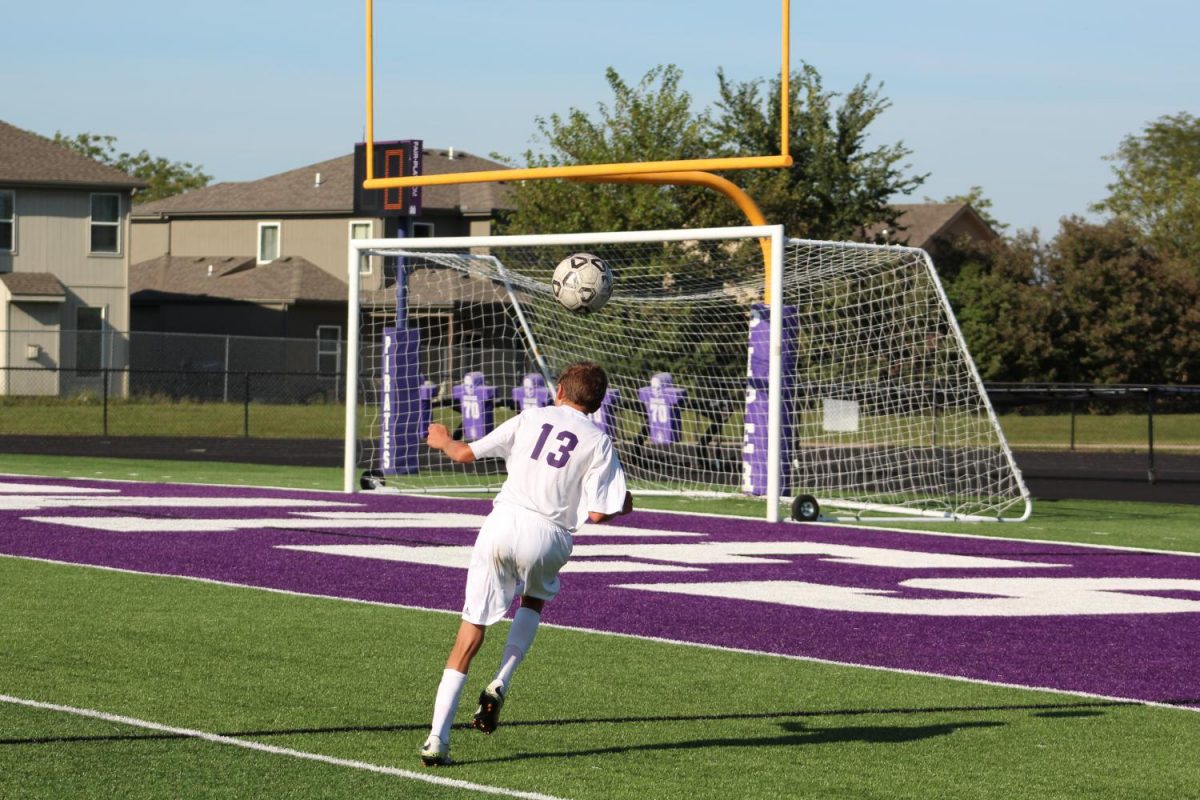 Sophomore Owen Roellchem practices heading the ball before the Turner game.