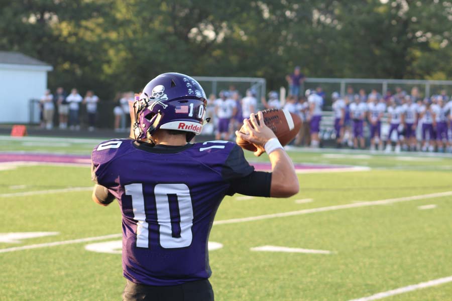 Quarterback Dalton White warms up his arm for the game. 