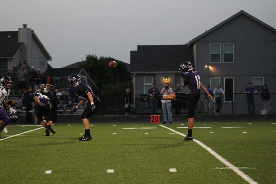 Junior Jonathan Moon punts the ball after 4th down.