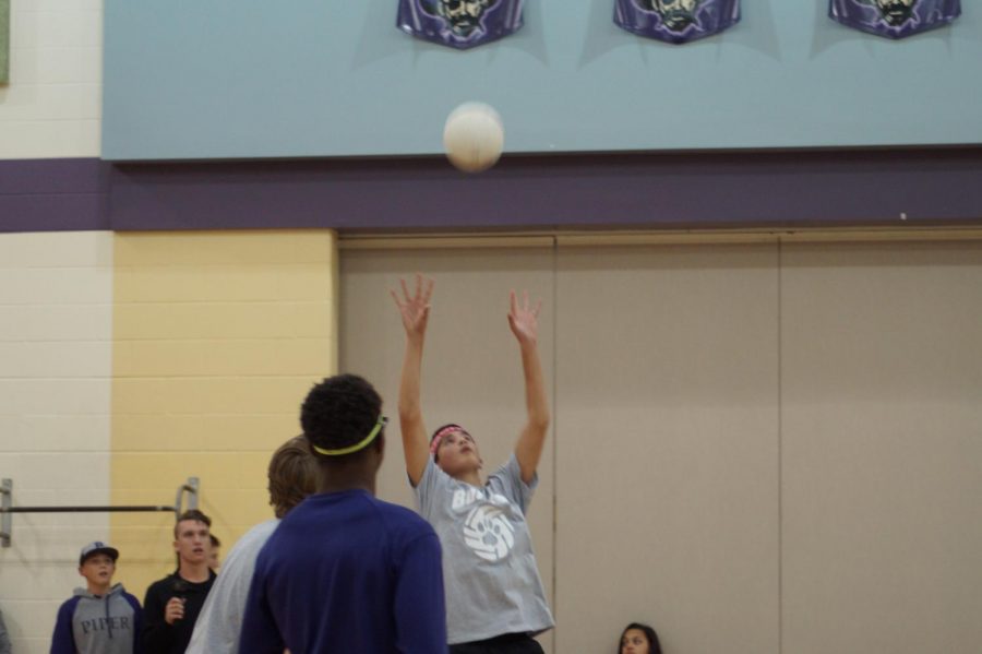 Sophomore Tyren Shelley sets the ball up for sophomore Brendyn Bard to spike it over the net. 