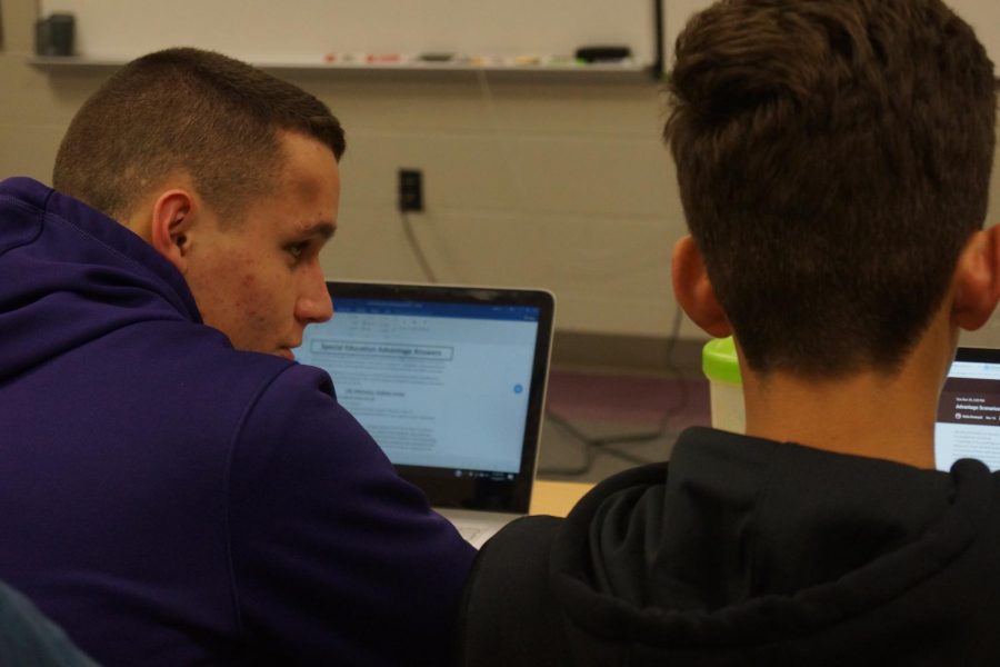Senior Tyler Ash and junior Colton Lloyd look at the upcoming assignment during squad night Nov. 29.