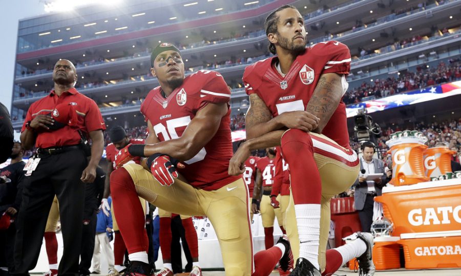 Colin Kaepernick kneels during the national anthem