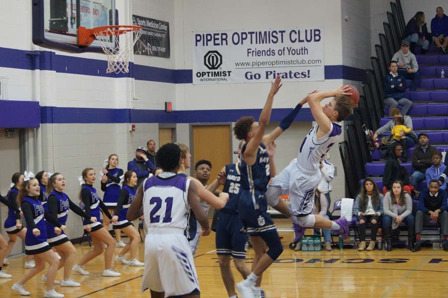 Senior Bryce Yoder flies in the air scoring a basket toward the end of the game against Hayden Dec. 12. 