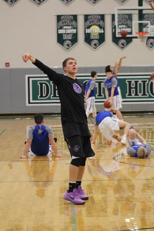 Senior Bryce Yoder warms up before the game with a three. 