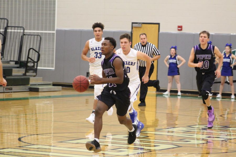 Junior Trey Bates looks up to pass on fastbreak.