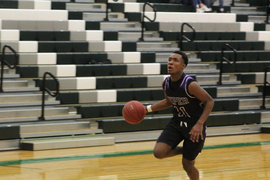 Junior Trey Bates goes up for a fastbreak layup.