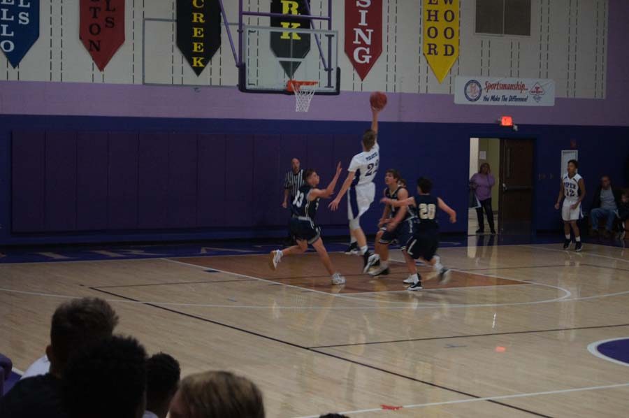 Sophomore Brendyn Bard beats the buzzer at the end of the first quarter to extend the Pirates’ lead over Hayden in the JV game on Dec. 12. 