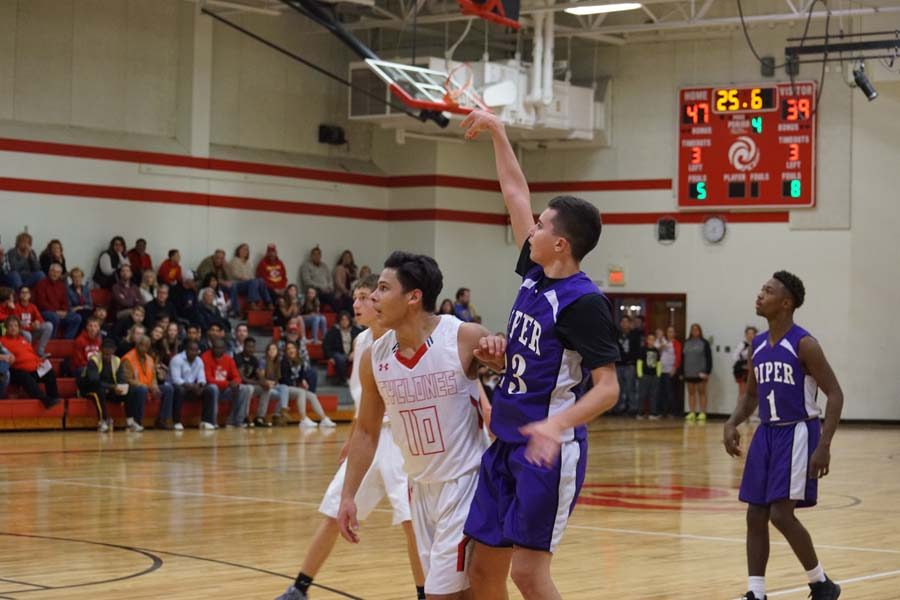 Tyren Shelley shoots a three, helping the Pirates catch up to Ottowa. 