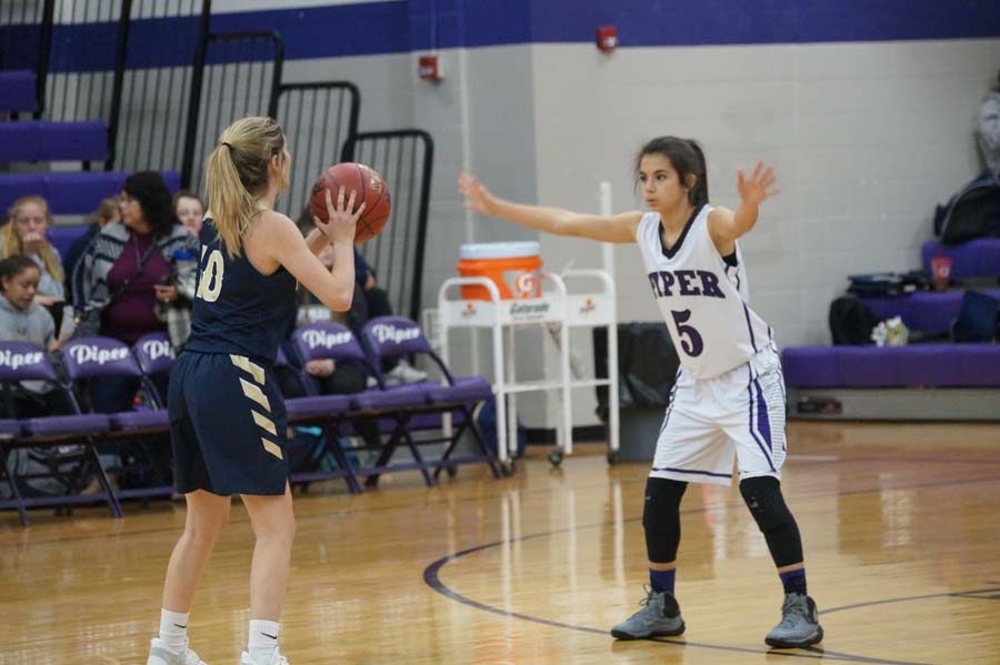 Junior Briana Andrade guards #10 of Topeka Hayden in the third quarter, so they don’t score another point.