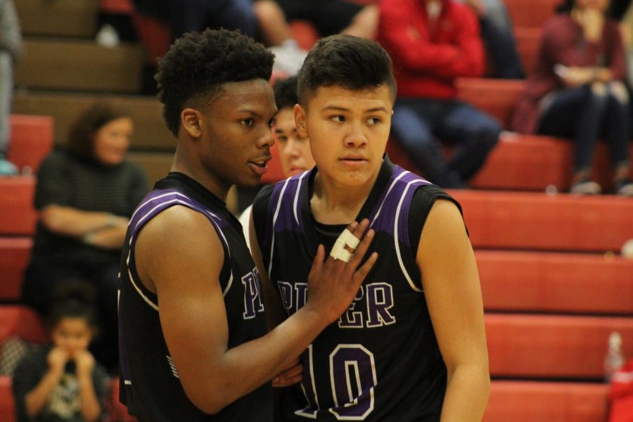 Senior Doc Covington and Gabriel Eskina talk about the next play.