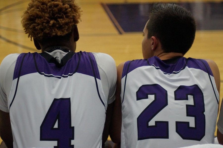 Junior Braijion Barnes and Sophomore Tyren Shelly watch as the pirates varsity boys struggle to keep the lead against Topeka Hayden 