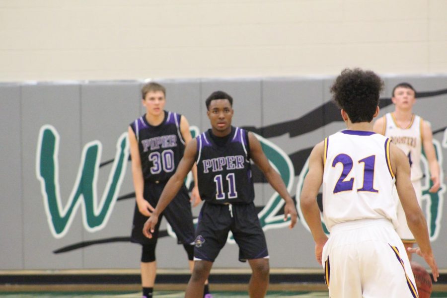 Junior Trey Bates gets prepared to play defense on Pleasant Hill Guard.