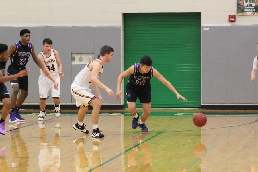 Sophomore Gabriel Eskina steals the ball and prepares to dribble up court.