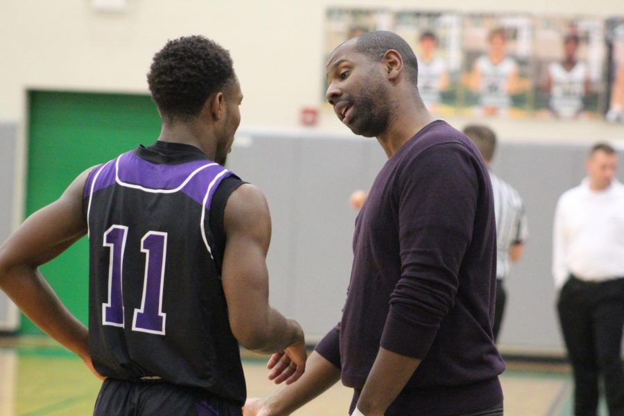 Coach Touré Grimes talks to Junior Trey Bates after subbing him out of the game.