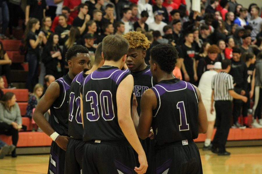 Seniors Bryce Yoder and Doc Covington talk to Juniors Trey Bates and Braijon Barnes during the game.