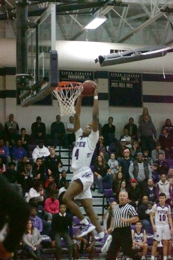 Braijion Barnes leaps to the goal going for a dunk.