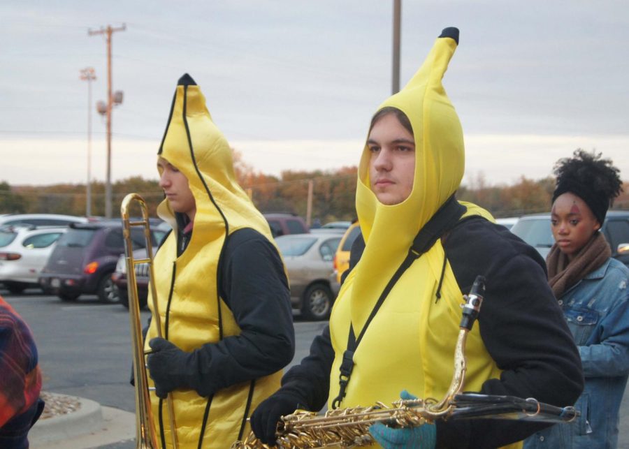 Junior Jamison Foglesong and senior Michael Gentry prepare to march down to the field for pre-show at the last varsity football game of the season.  The whole band dressed in costumes to celebrate Halloween.