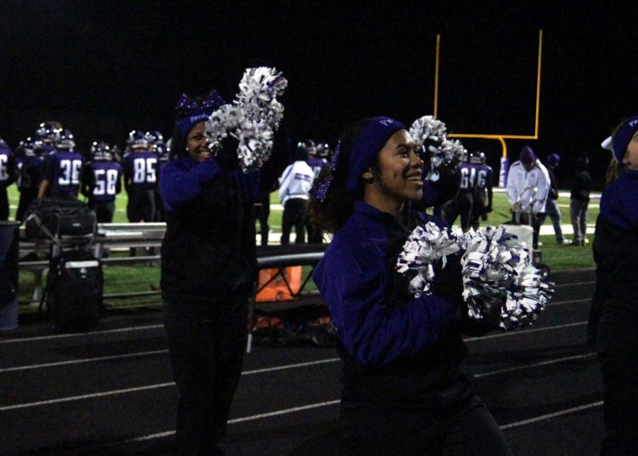 Junior Jada Simmons and the cheer team energize the crowd at the varsity football game against Atchison.