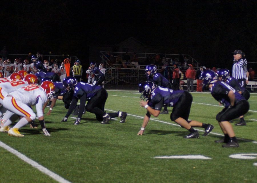 The Pirates prepare to block Atchison from charging down the field.