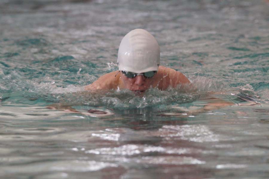 Sophomore Carson Gardner takes a breath while swimming 100m breaststroke. 