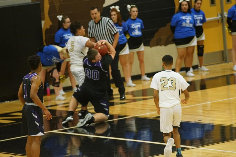 Junior Cooper Beebe steals the ball away from Turners player/ 