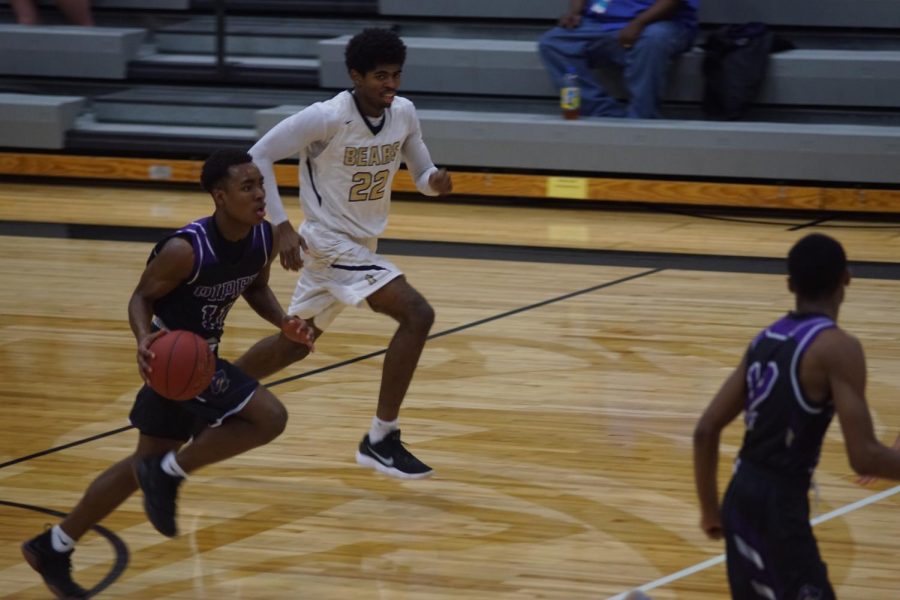 Junior Trey Bates runs the ball down the court looking for someone to pass to. 
