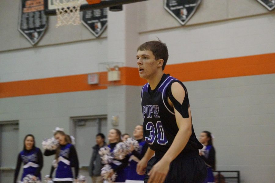 Senior Bryce Yoder begins to rush down the court as Piper gains possession of the ball Jan. 12. 