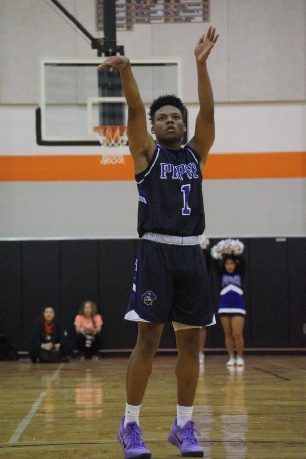 Senior Daviance Covington shoots a free throw to add an extra point for the Pirates to fight against Bonner's lead.