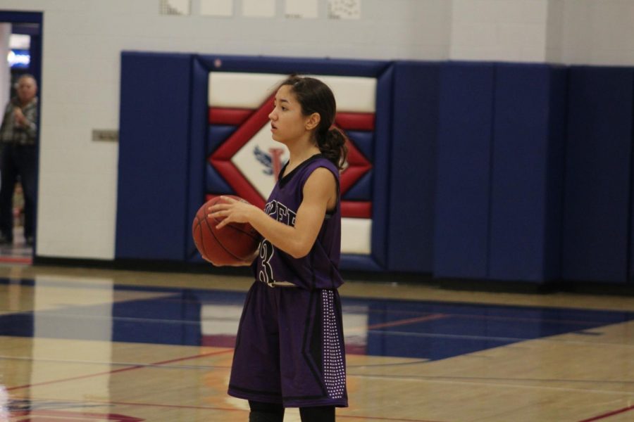 Freshman Evelyn Vazquez surveys the floor before passing.