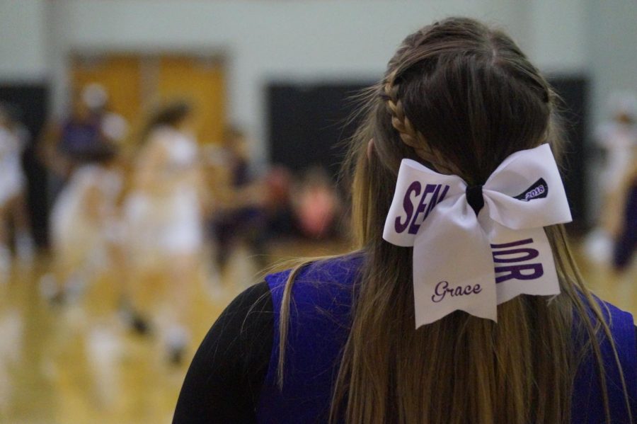 Senior cheer co-captain Grace Vogel cheers on the Lady Pirates as they defeat the Bonner Braves.