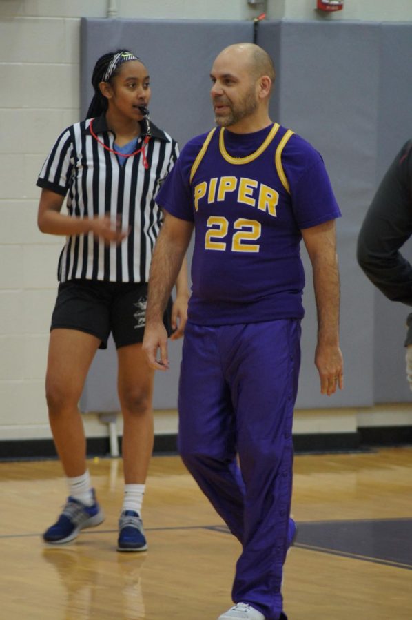 English teacher Scott Teufel shows off his piper spirit at the teacher vs. teacher basketball game on Feb. 9