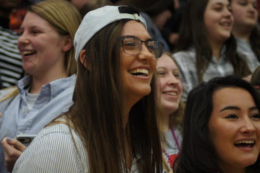 Junior Alison Vigil laughs while watching the teacher vs. teacher basketball game