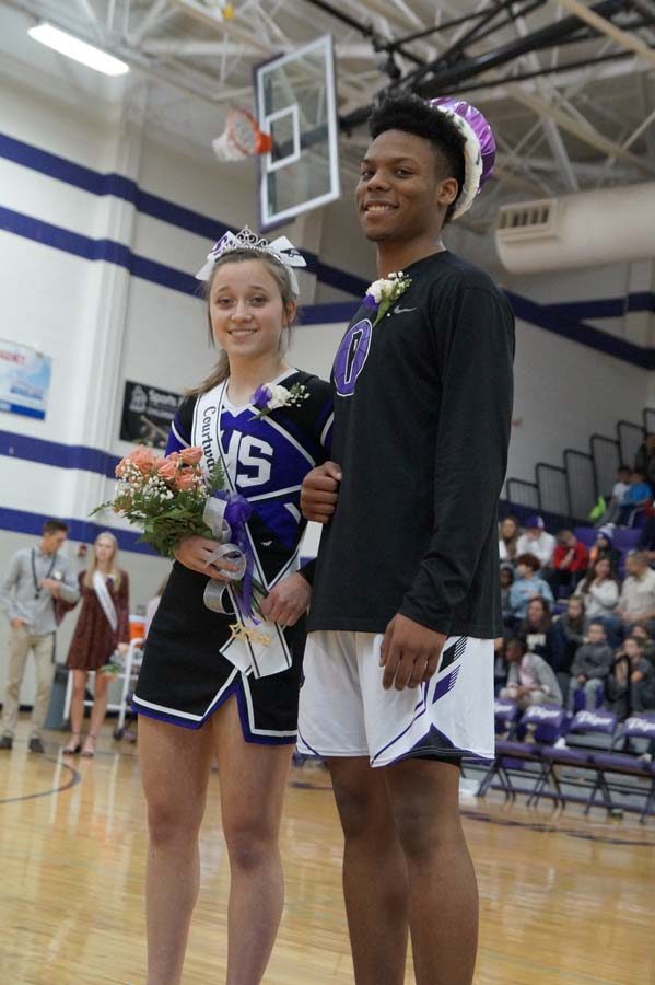 Seniors Daviance Covington and Sophia Frick stand in front of the crowd after accepting their crowns.
