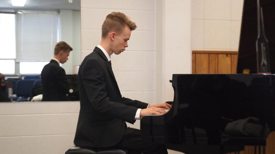 Sophomore Philipp Bretschneider warms up before performing in front of the judge at the regional piano festival Feb. 3.