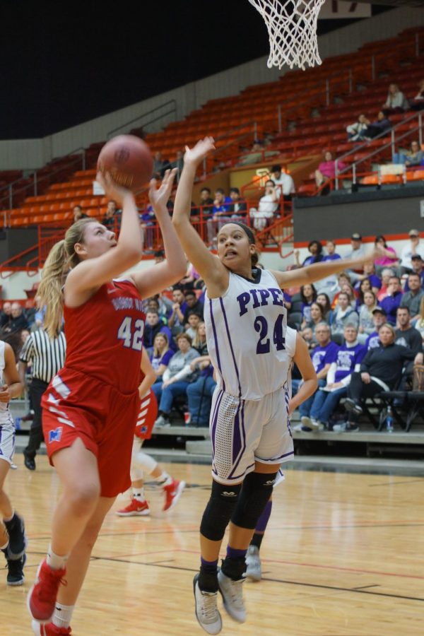 Junior Lakaya Leslie goes up for a block against 42 at game 3 of the state tournament.